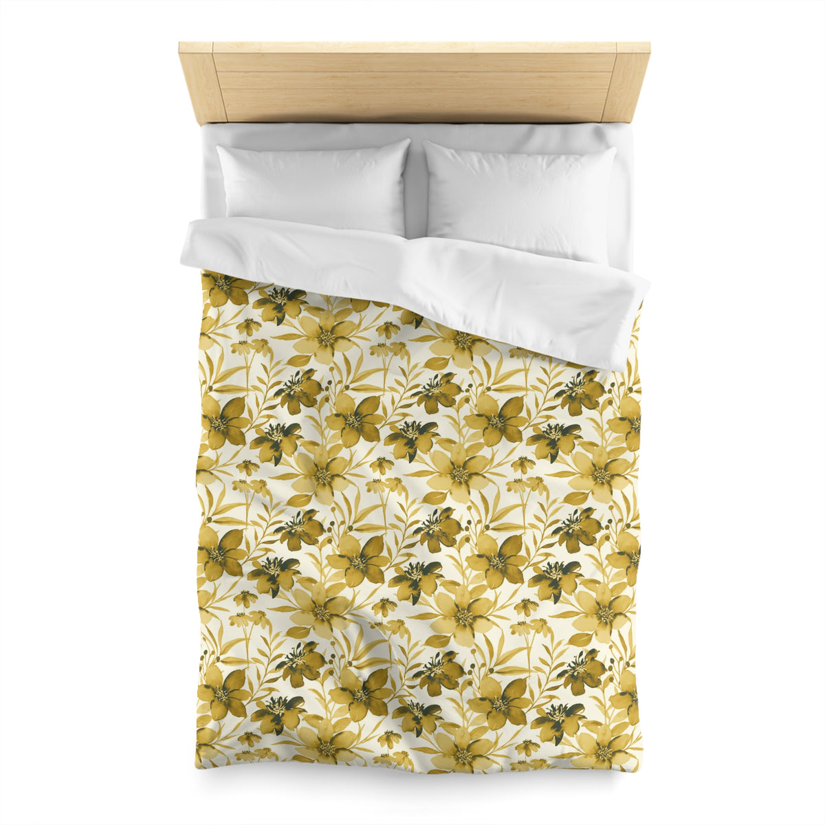 a bed with a yellow and white floral patterned comforter and pillows.