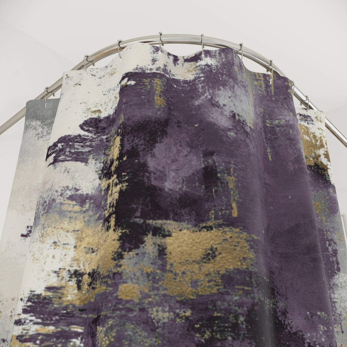 a curtain with a purple and gold abstract design, hanging from a rod.