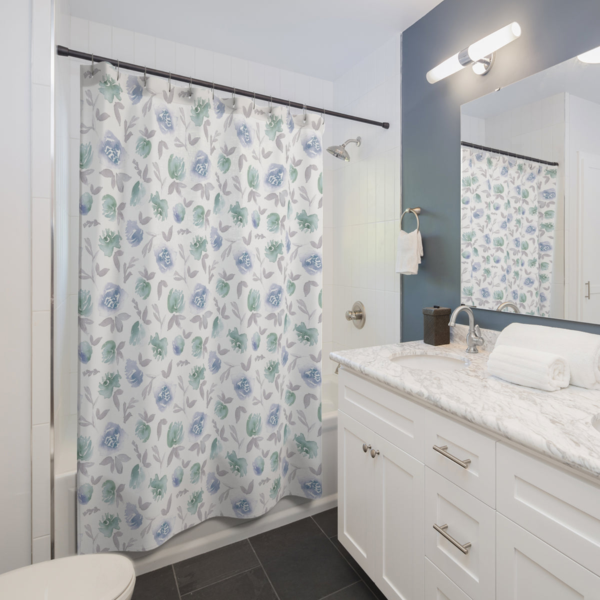 a well-organized bathroom with a white vanity, a shower curtain with a floral pattern, and a mirror above the sink.
