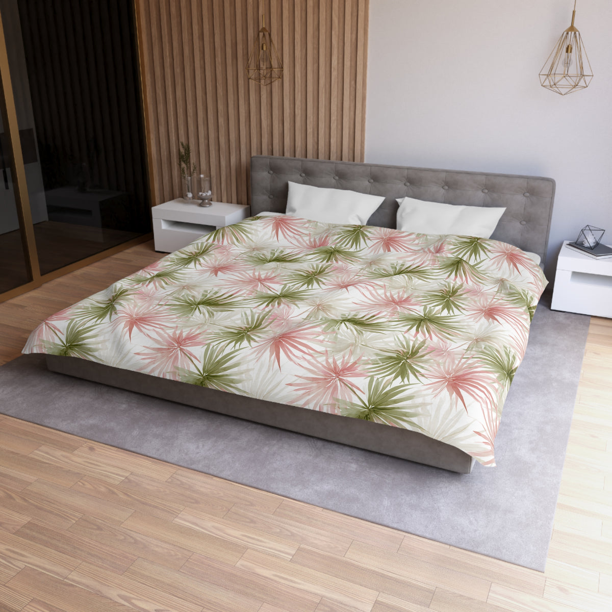 a modern bedroom with a large bed, a gray headboard, and a green and white floral comforter. The room has a wooden floor and white walls, creating a serene and stylish atmosphere.