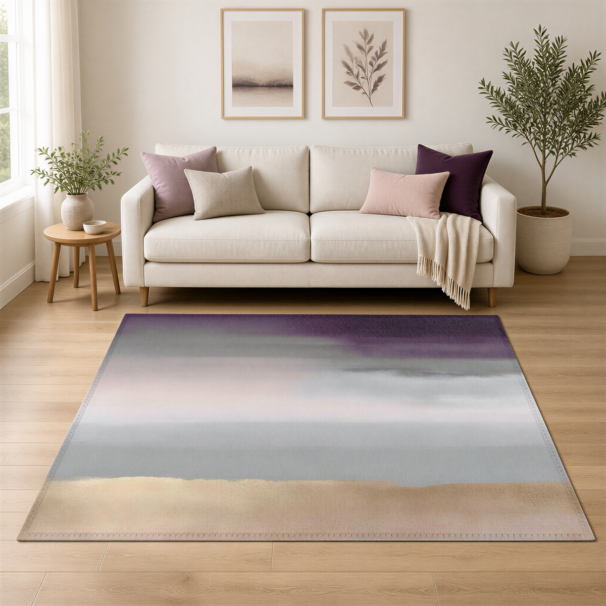 a living room with a white sofa, a rug with a gradient design, and two framed pictures on the wall. The room also includes a potted plant and a vase, creating a cozy and inviting atmosphere.