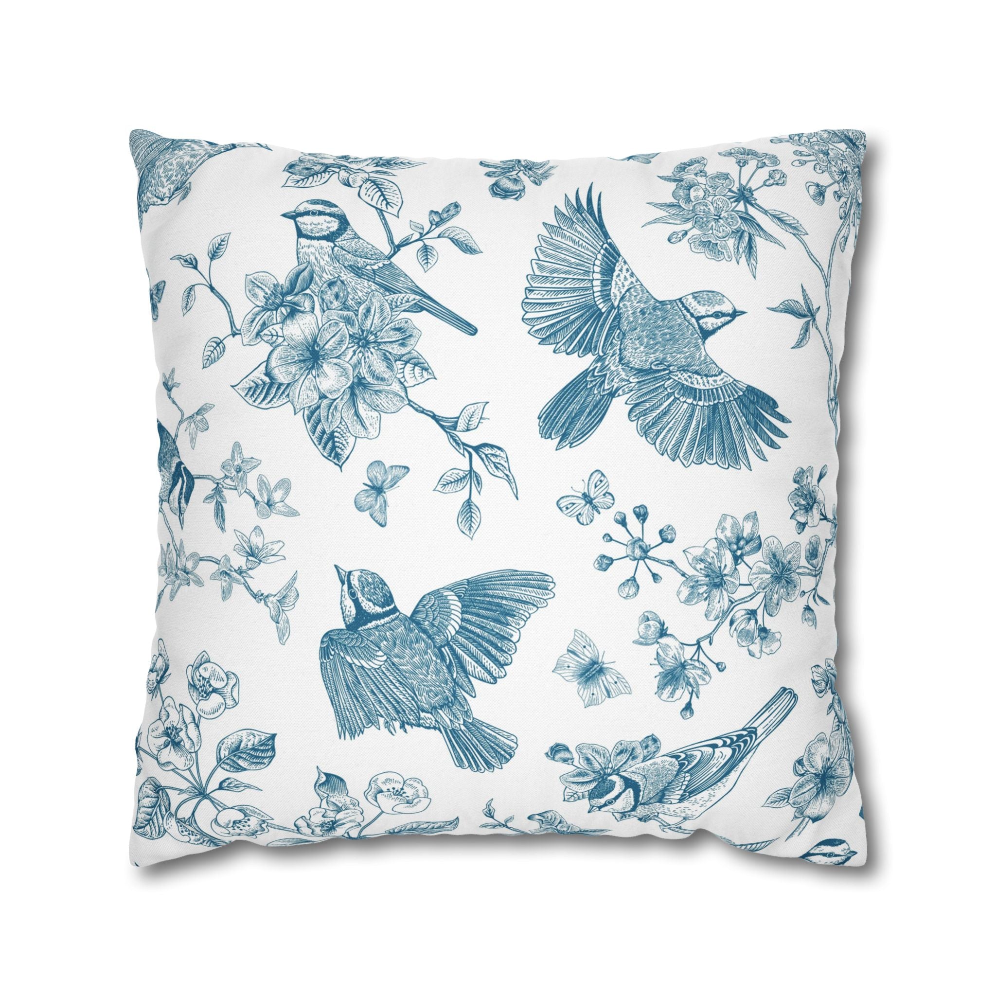a square pillow with a floral and bird motif printed on it.
