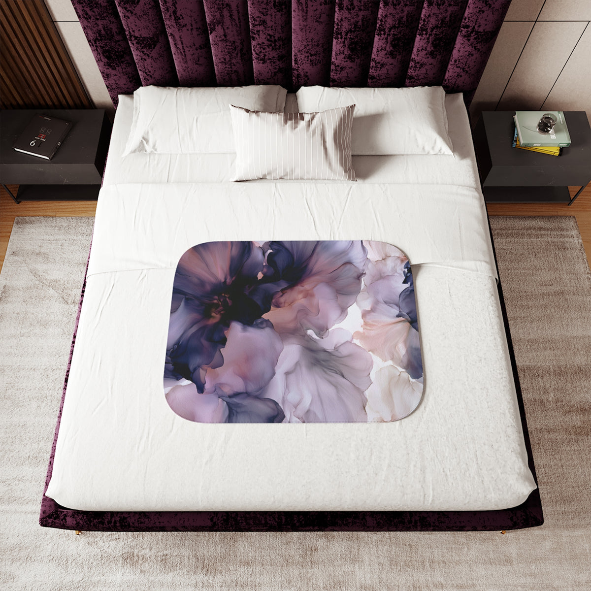 a bed with a purple floral comforter and pillows