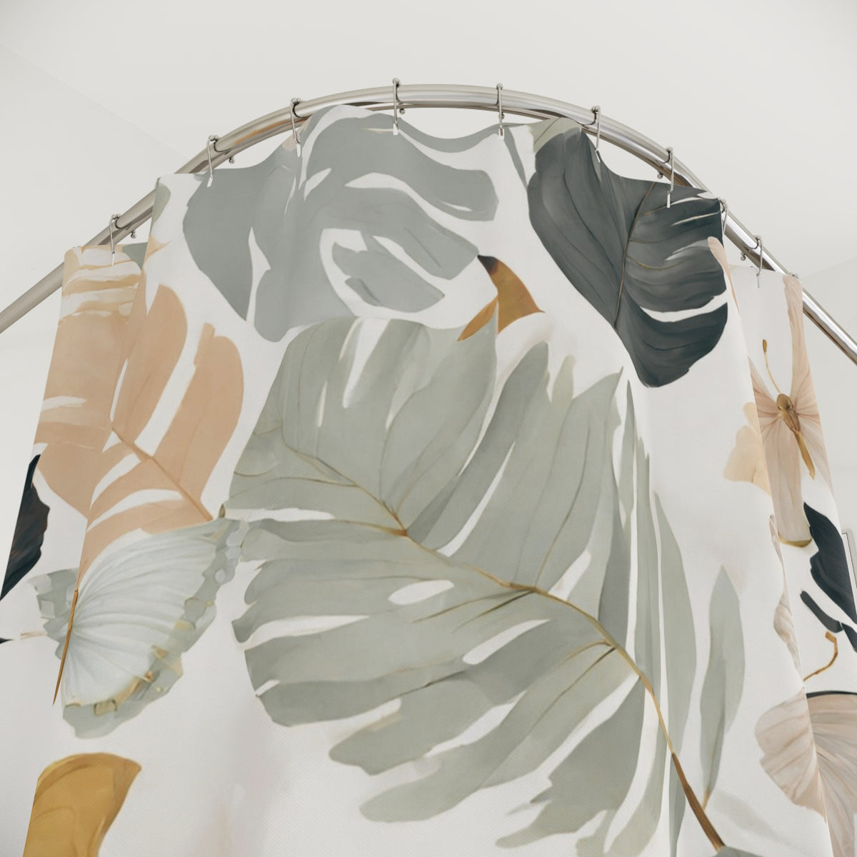 a shower curtain with a tropical leaf pattern in shades of green, gray, and beige.