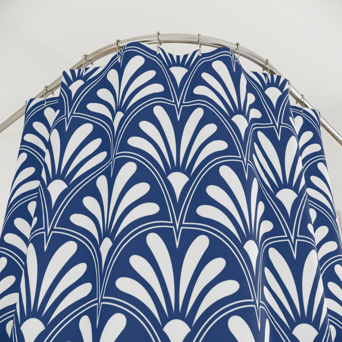 a blue and white patterned shower curtain hanging from a rod.