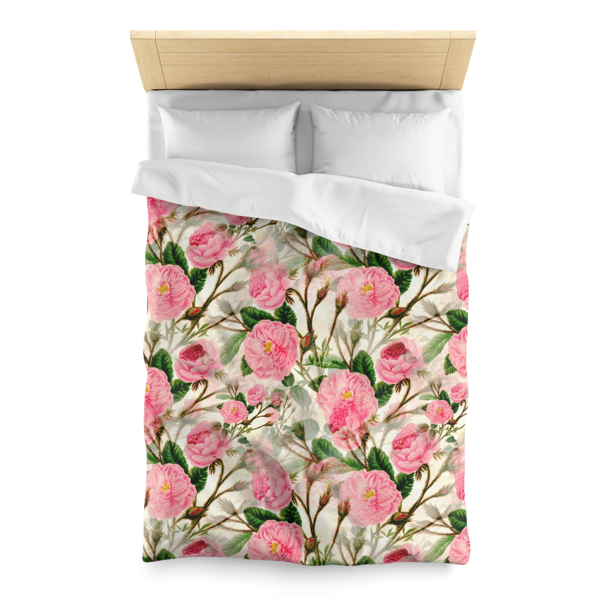 a bed with a floral patterned comforter and pillows.