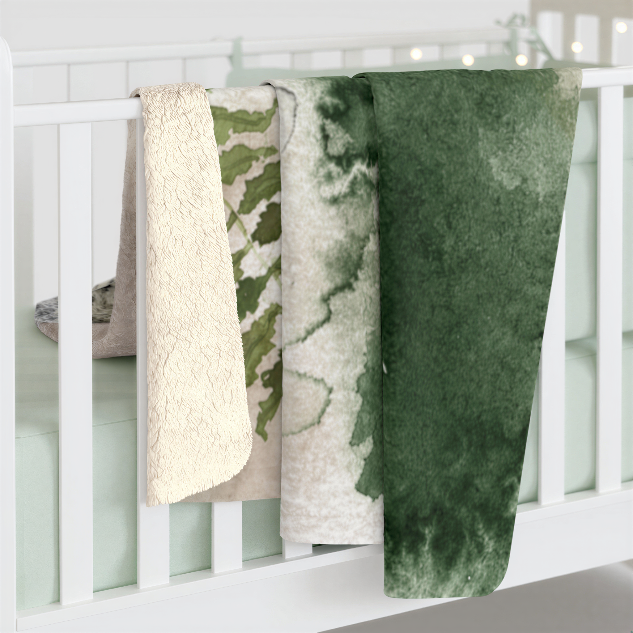 Black, ivory and forest green boho floral throw blanket on a bed
