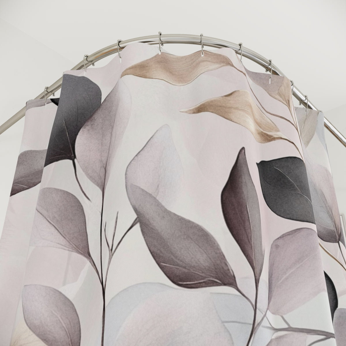 a shower curtain with a floral pattern of leaves and branches in shades of pink, gray, and brown.