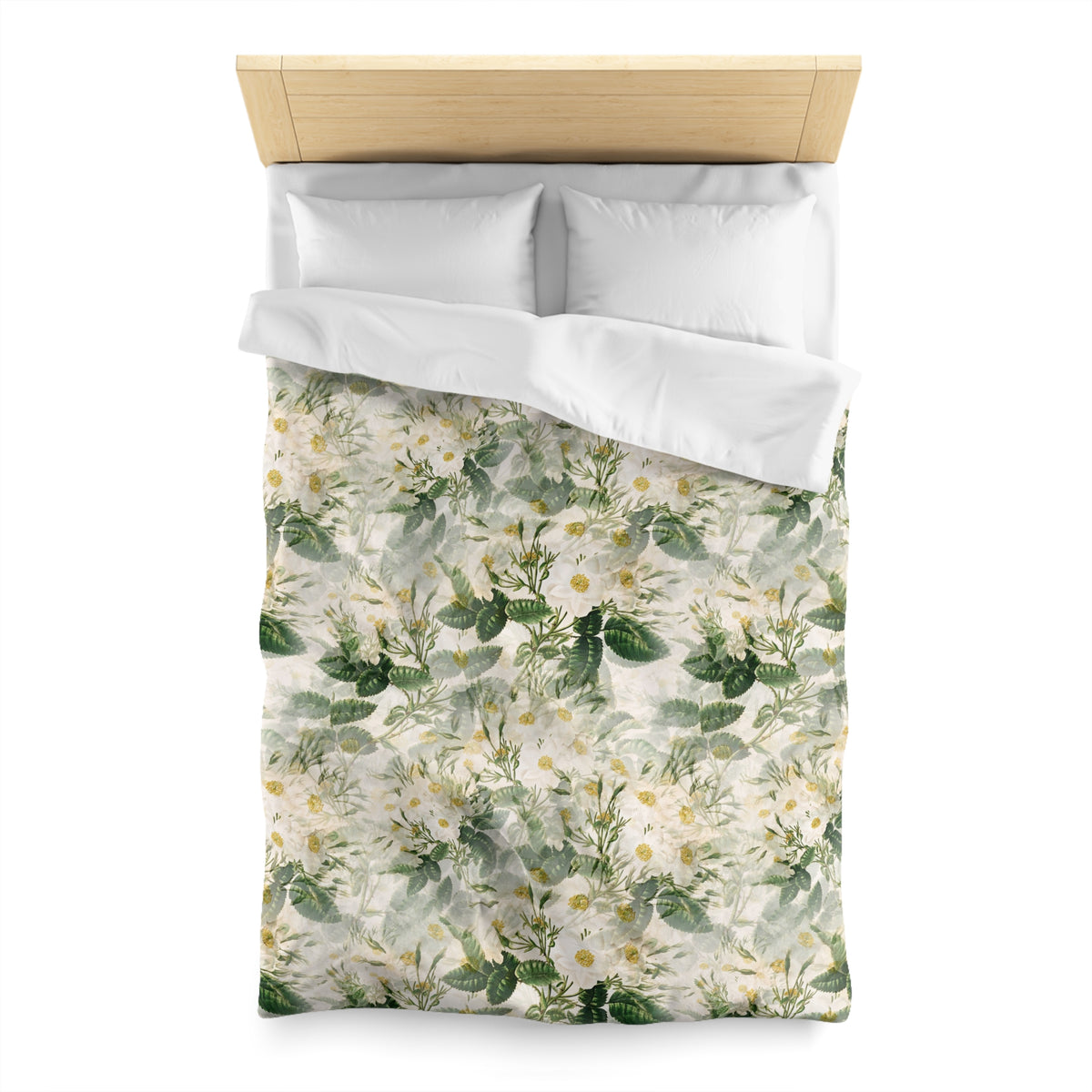 a bed with a floral print duvet cover and pillows.
