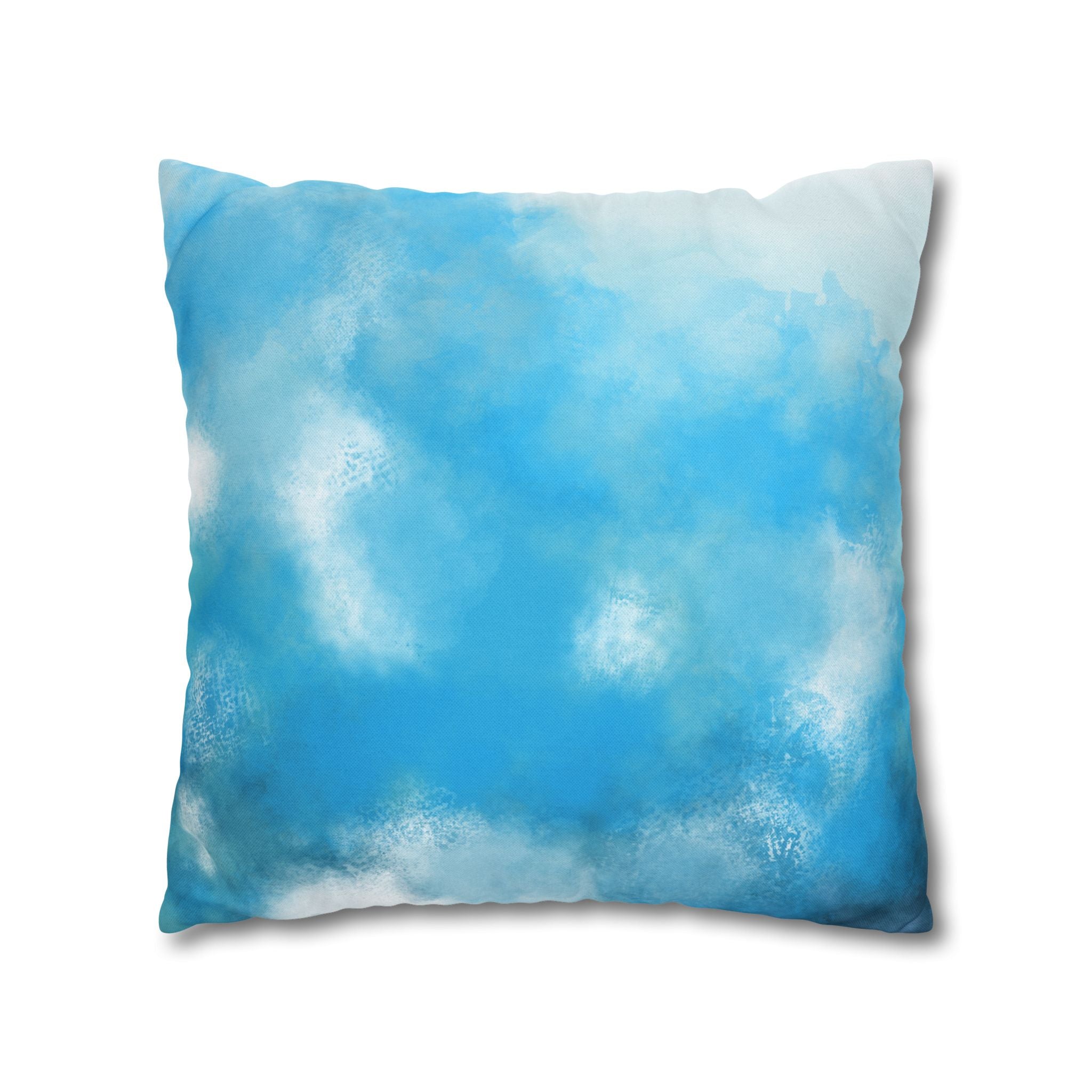 A square pillow with a blue and white abstract design, resembling a cloud or sky.