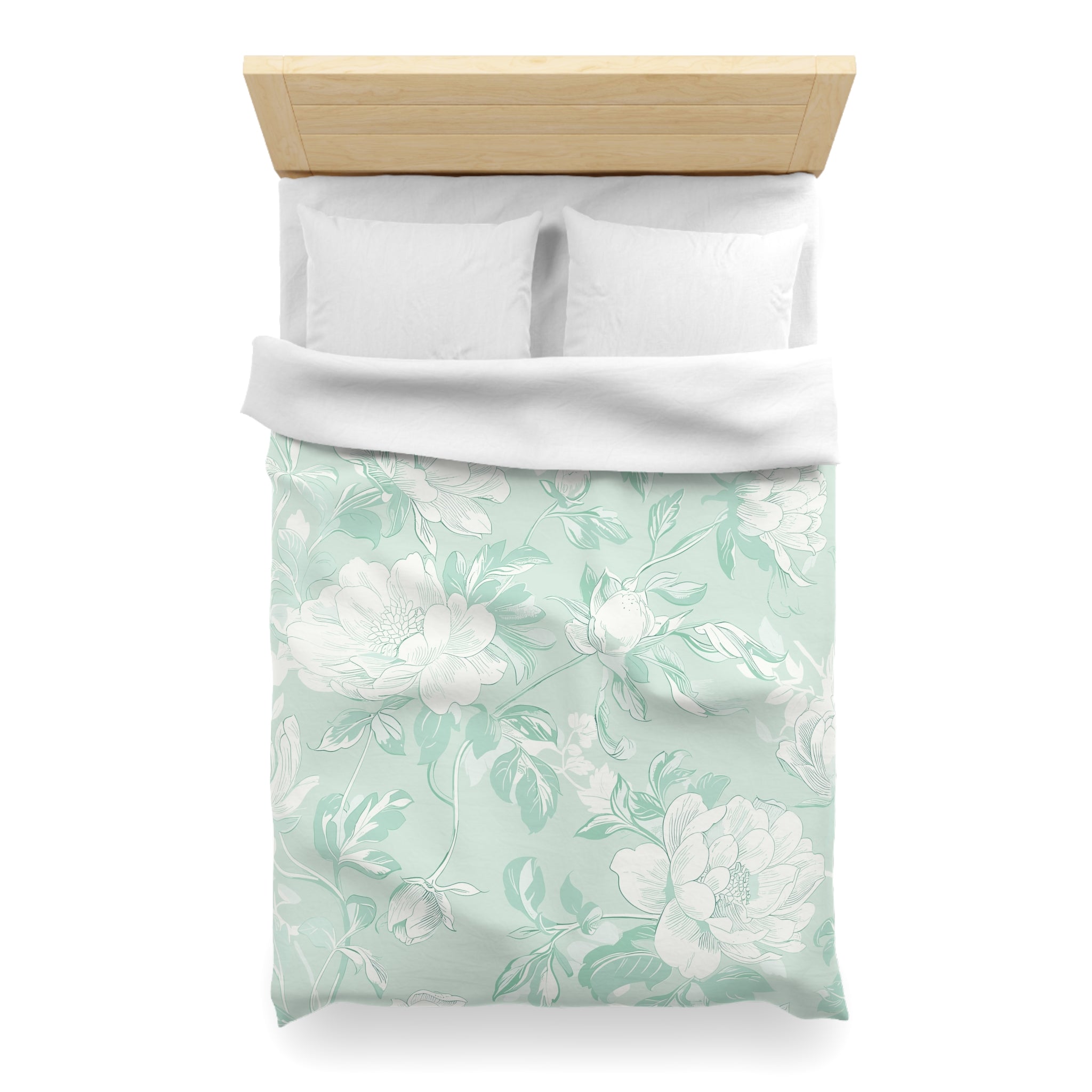 A neatly made bed with a white comforter and a floral patterned duvet cover.