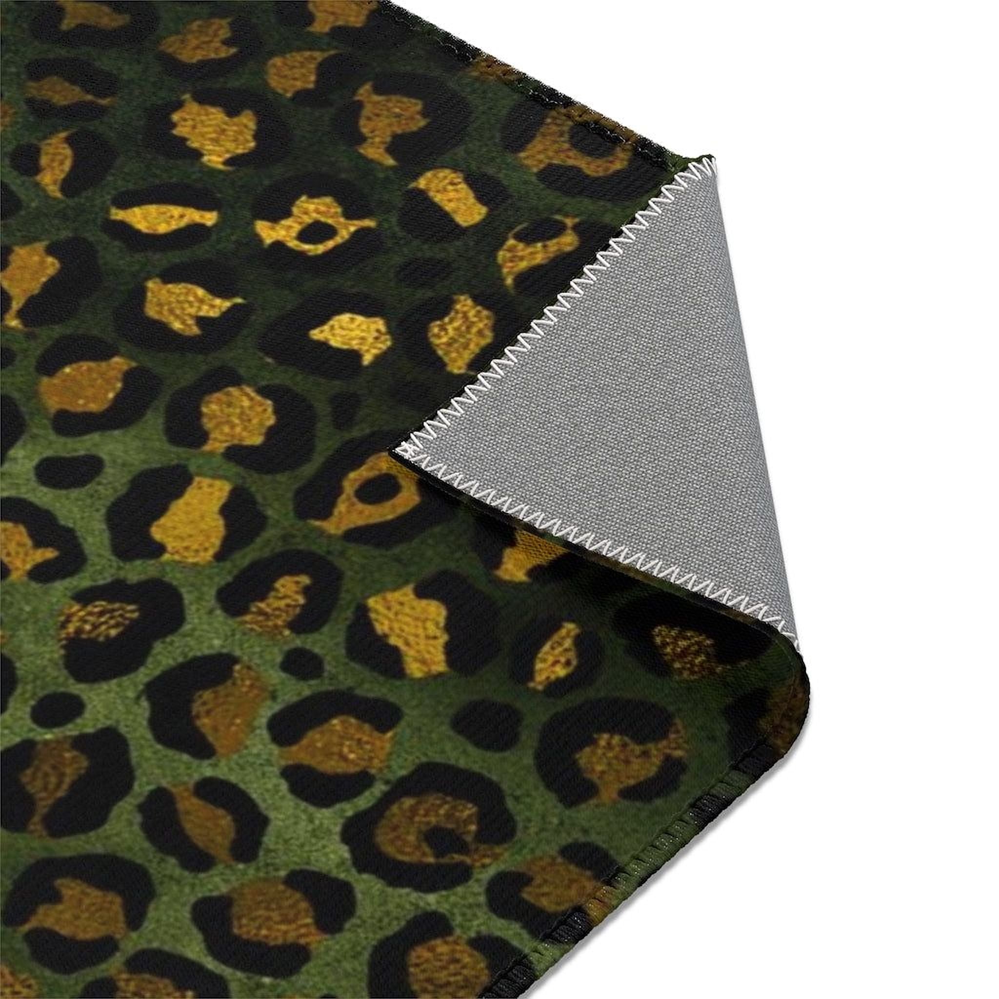 a close-up view of a leopard print fabric with a dark green background and gold accents.