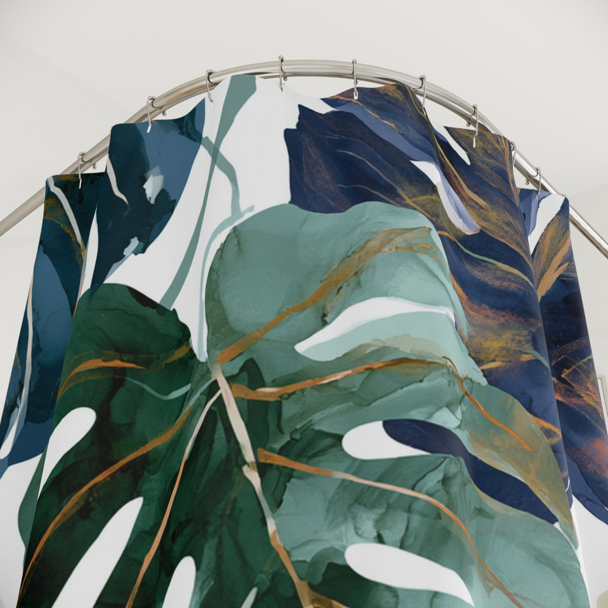 a shower curtain with a large, colorful leaf design in shades of green, blue, and gold.