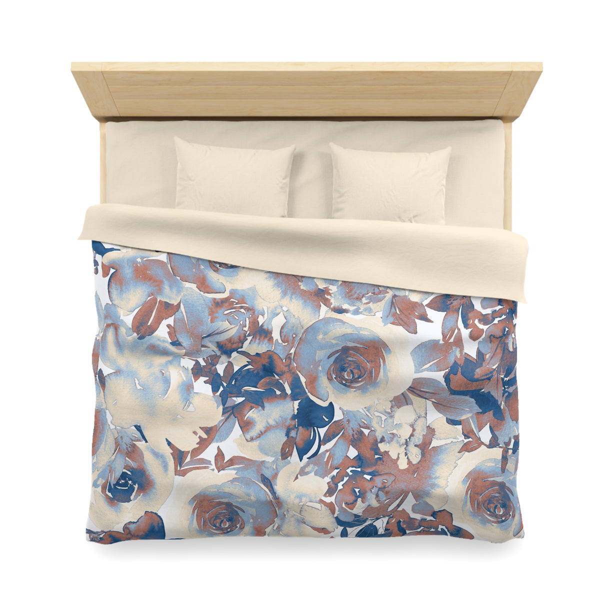 a bed with a floral print comforter and pillows.