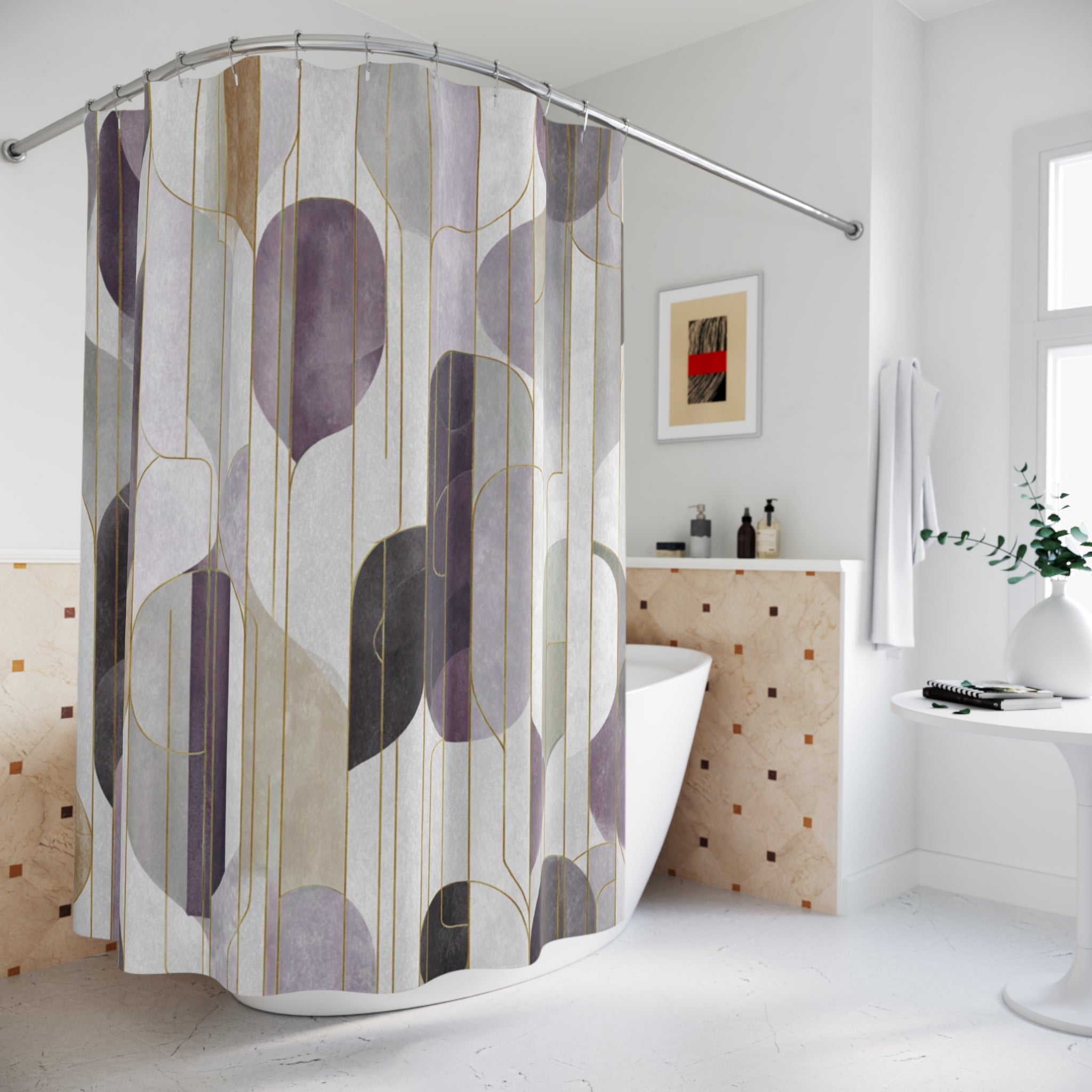 a modern bathroom with a shower curtain featuring a geometric pattern in shades of purple and gray. The bathroom is well-lit and has a white color scheme, with a white bathtub and a white countertop. There is a framed picture on the wall, and a white towel is hanging on a rack.