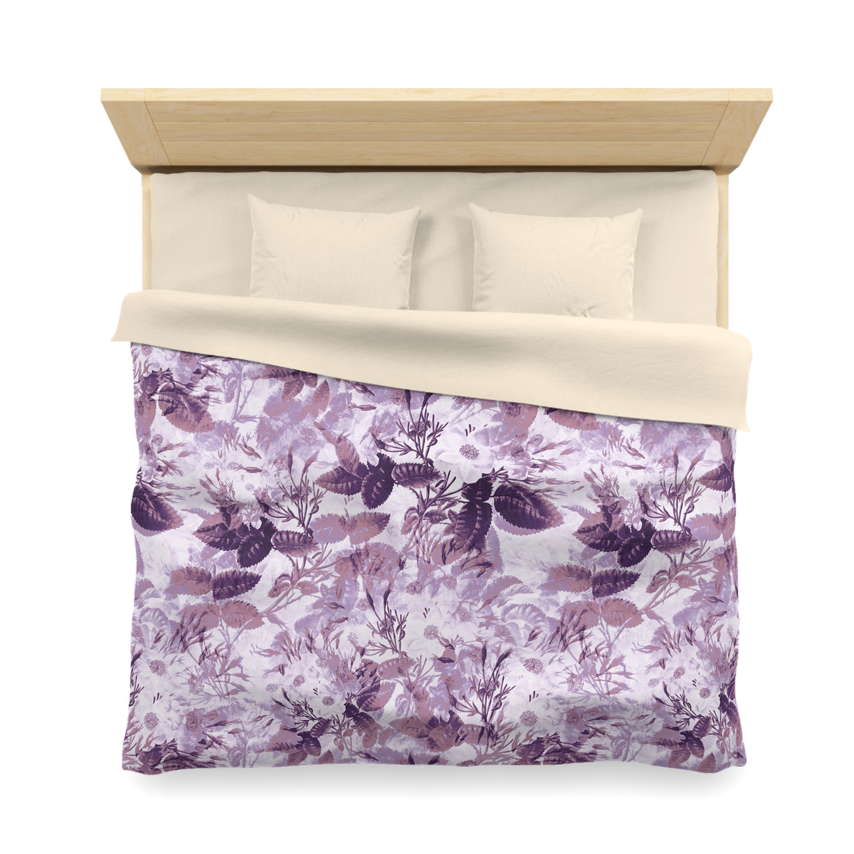 a neatly made bed with a floral print comforter and pillows.