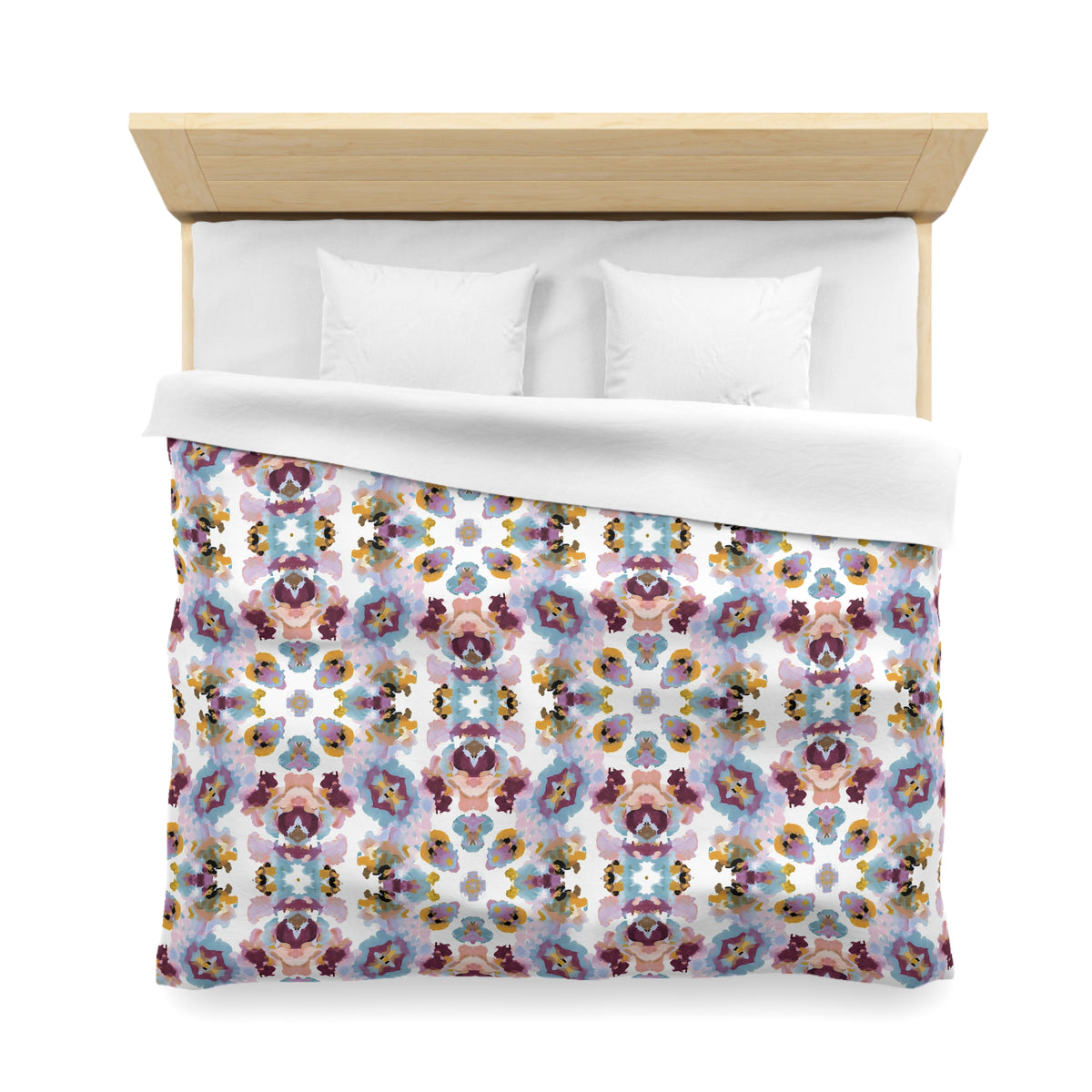 a bed with a colorful, patterned comforter and pillows.