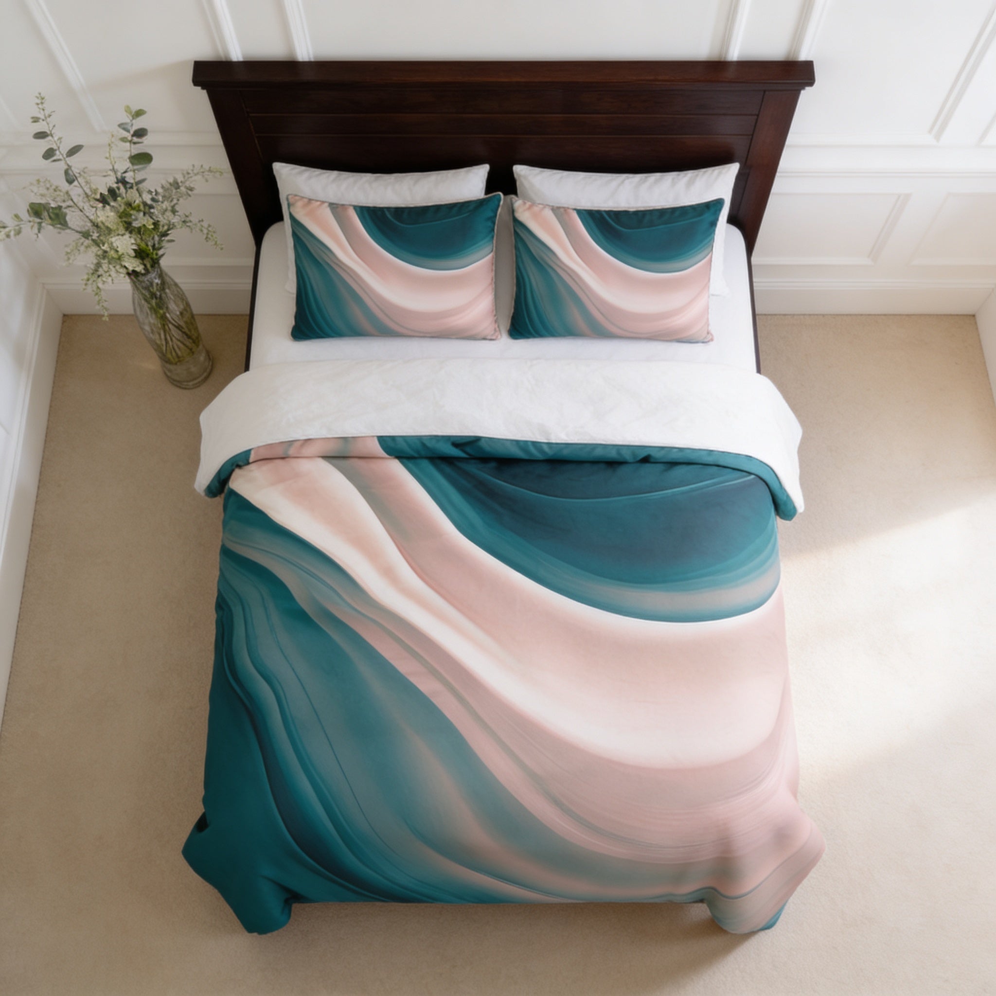 a bedroom with a bed featuring a colorful, abstract patterned comforter and pillows. The bed is positioned against a white wall, and there is a vase of flowers on the left side of the bed.
