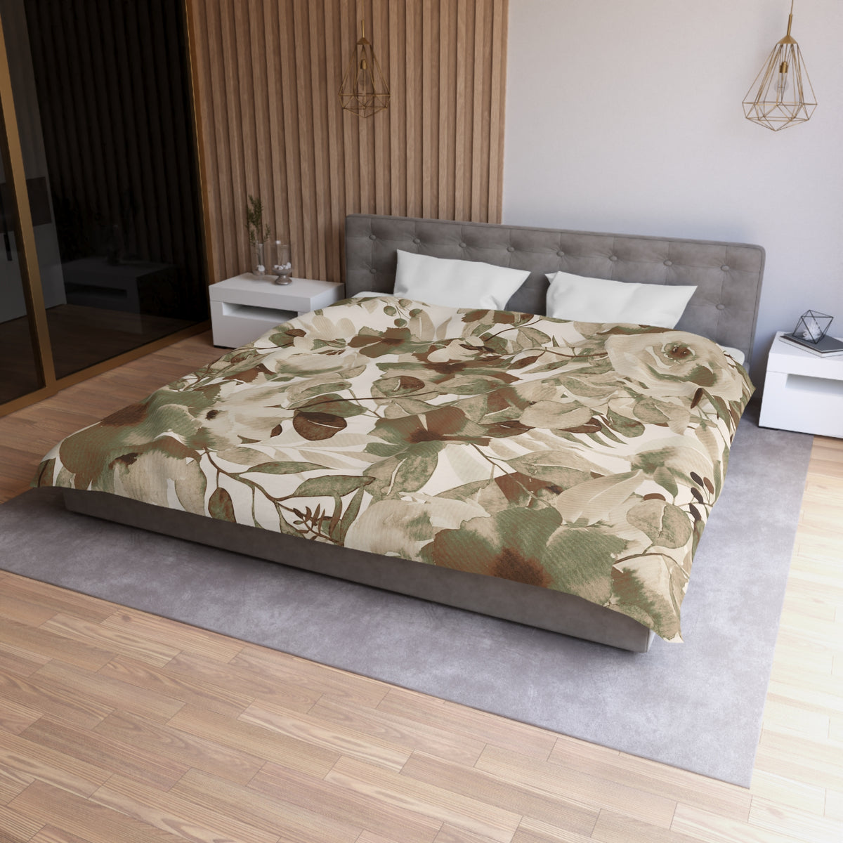 a modern bedroom with a large bed, a gray headboard, and a floral print bedspread. The room has a wooden floor and white walls, creating a serene and elegant atmosphere.