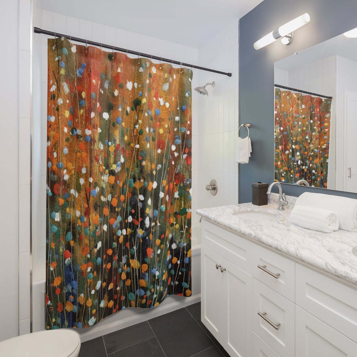 a modern bathroom with a white vanity, a colorful shower curtain featuring a floral pattern, and a mirror above the vanity.