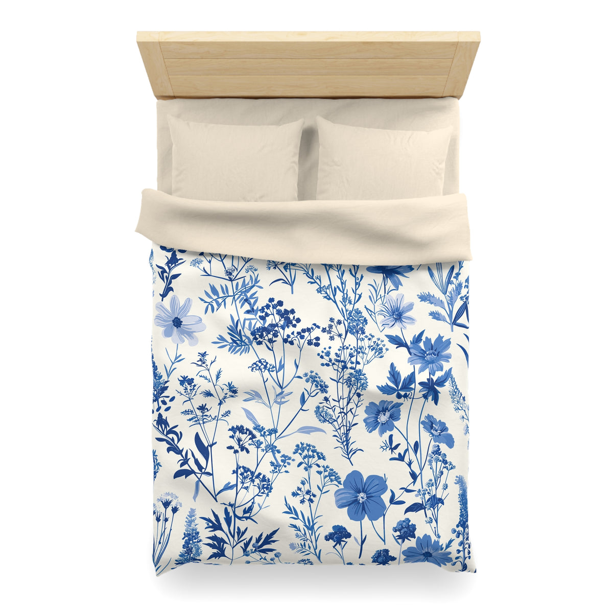 a neatly made bed with a blue and white floral patterned comforter and pillows.
