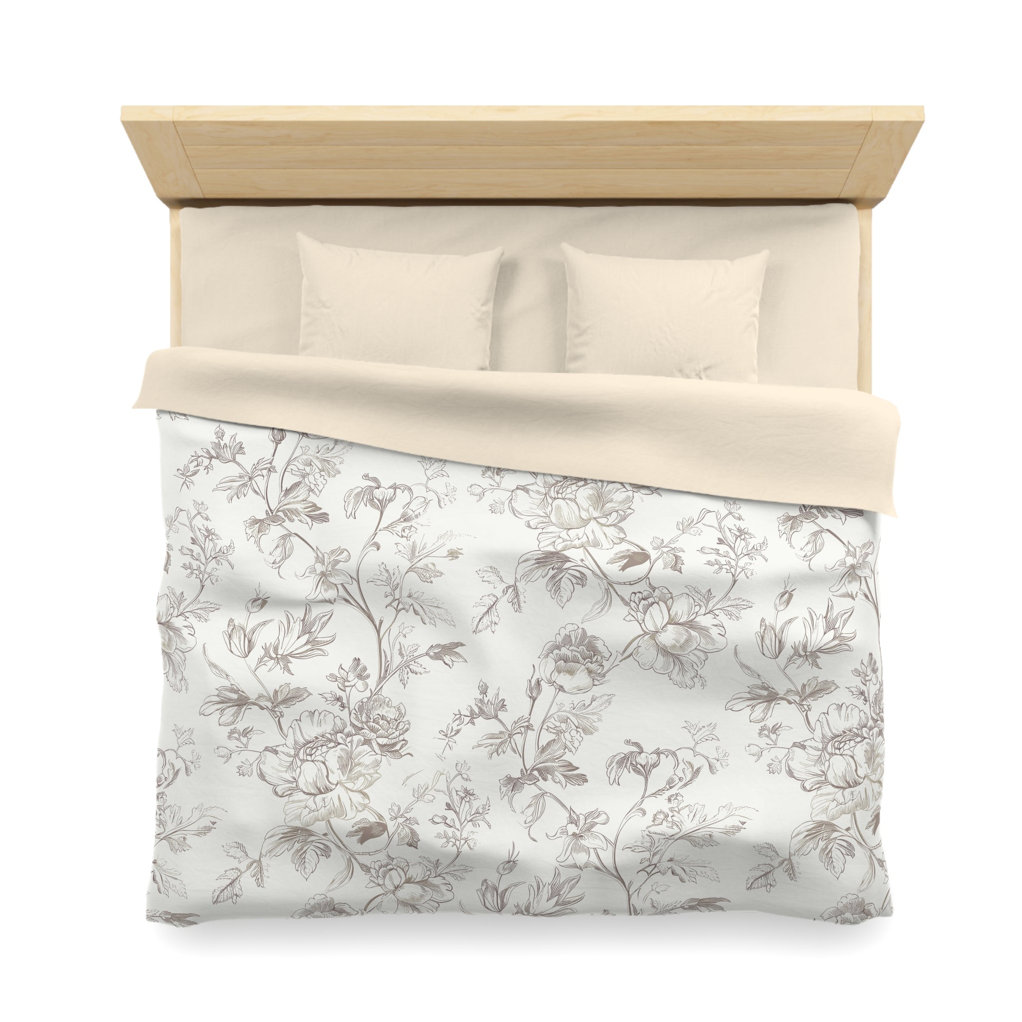 a neatly made bed with a floral patterned comforter and pillows.