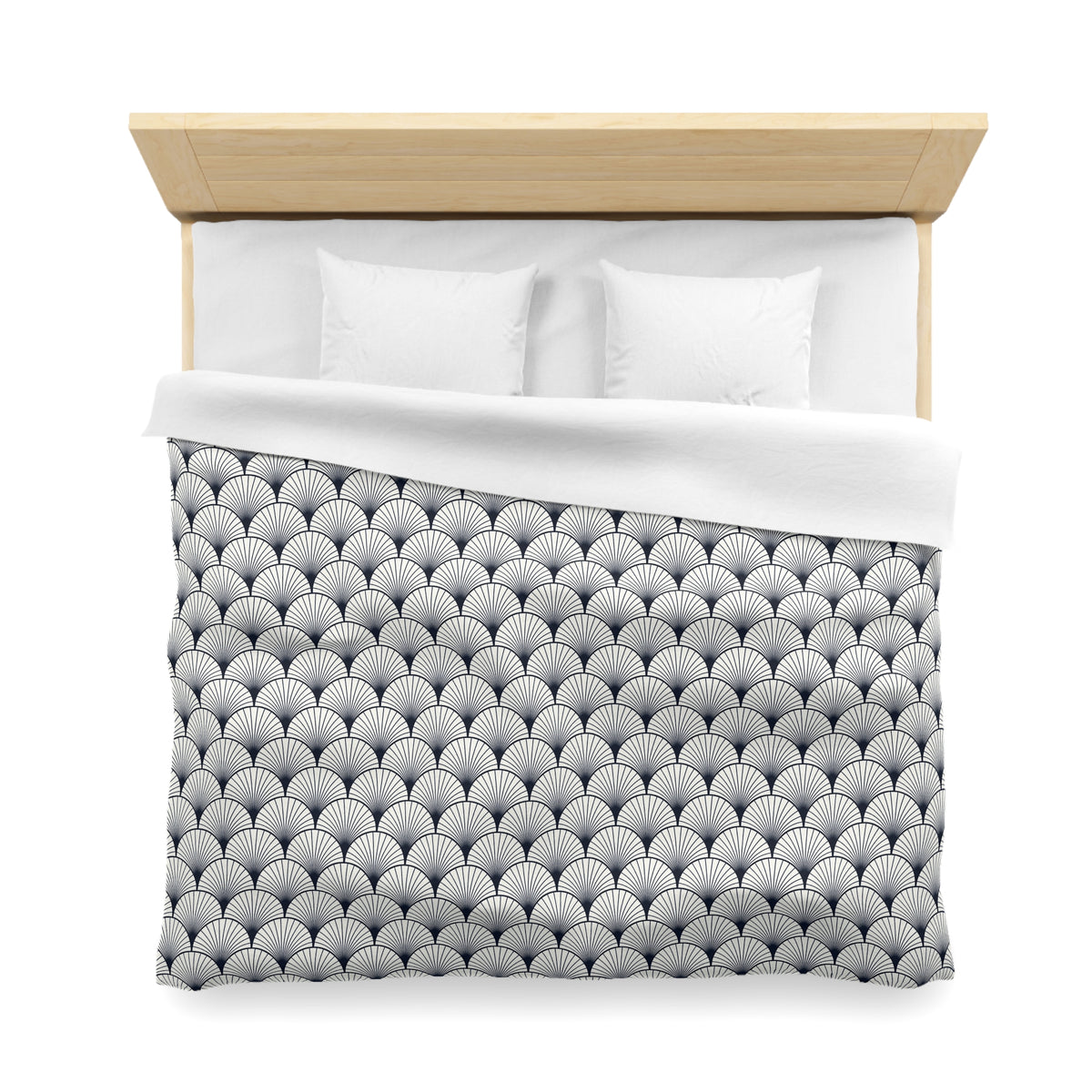 a neatly made bed with a patterned comforter and pillows.