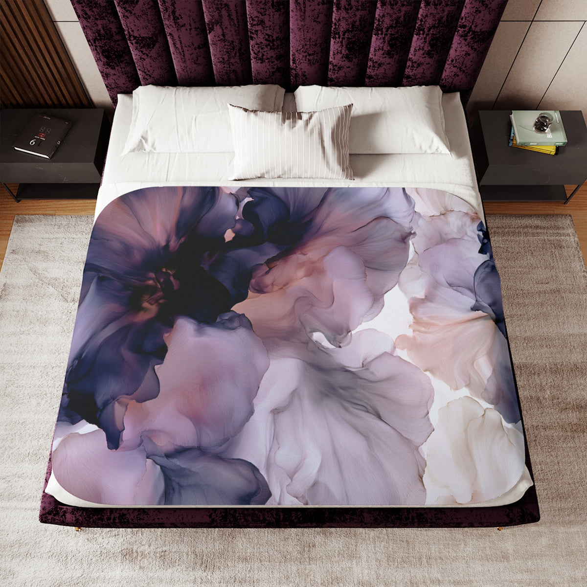 a bed with a purple flower comforter on top of it