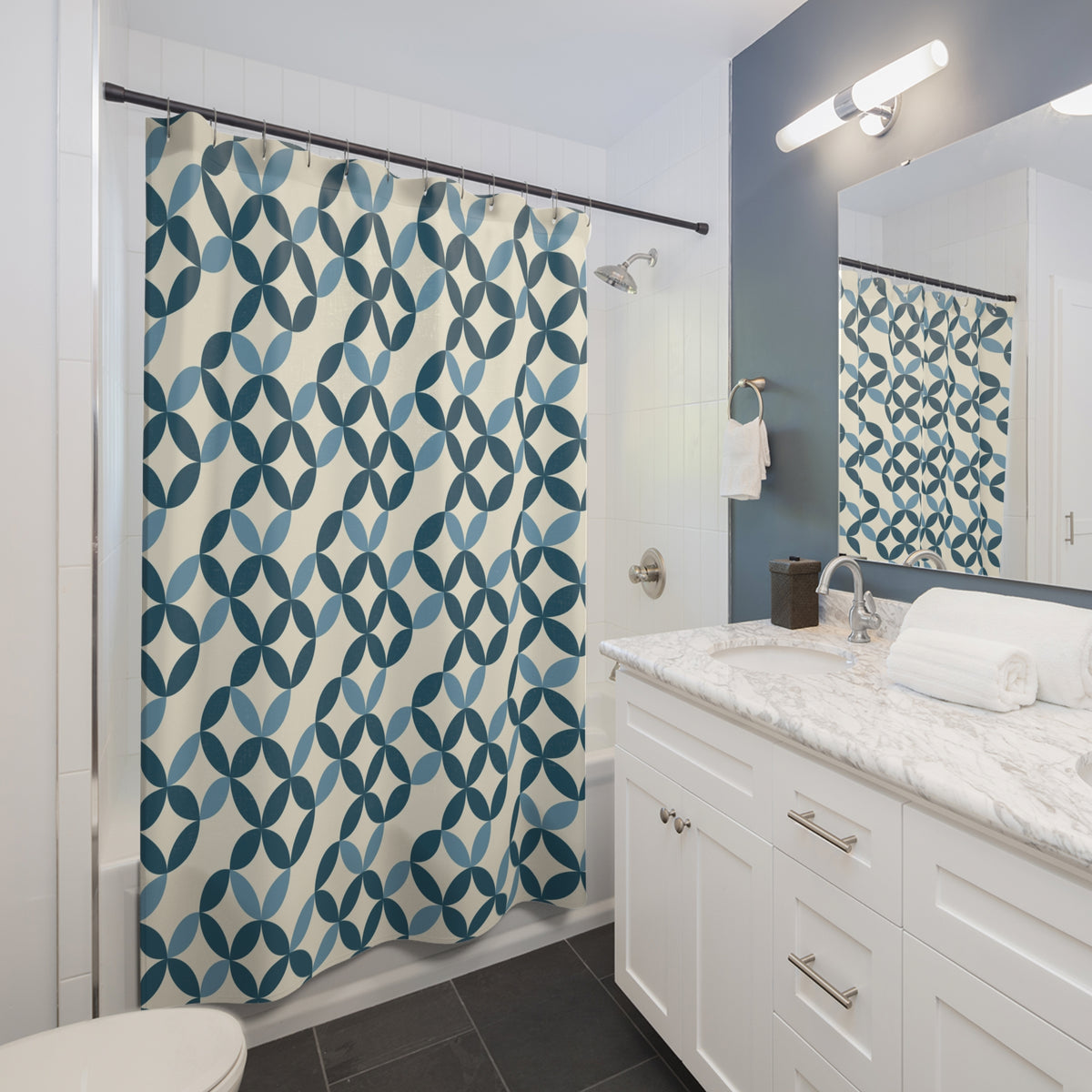 a modern bathroom with a white vanity, a blue and white patterned shower curtain, and a mirror above the sink.