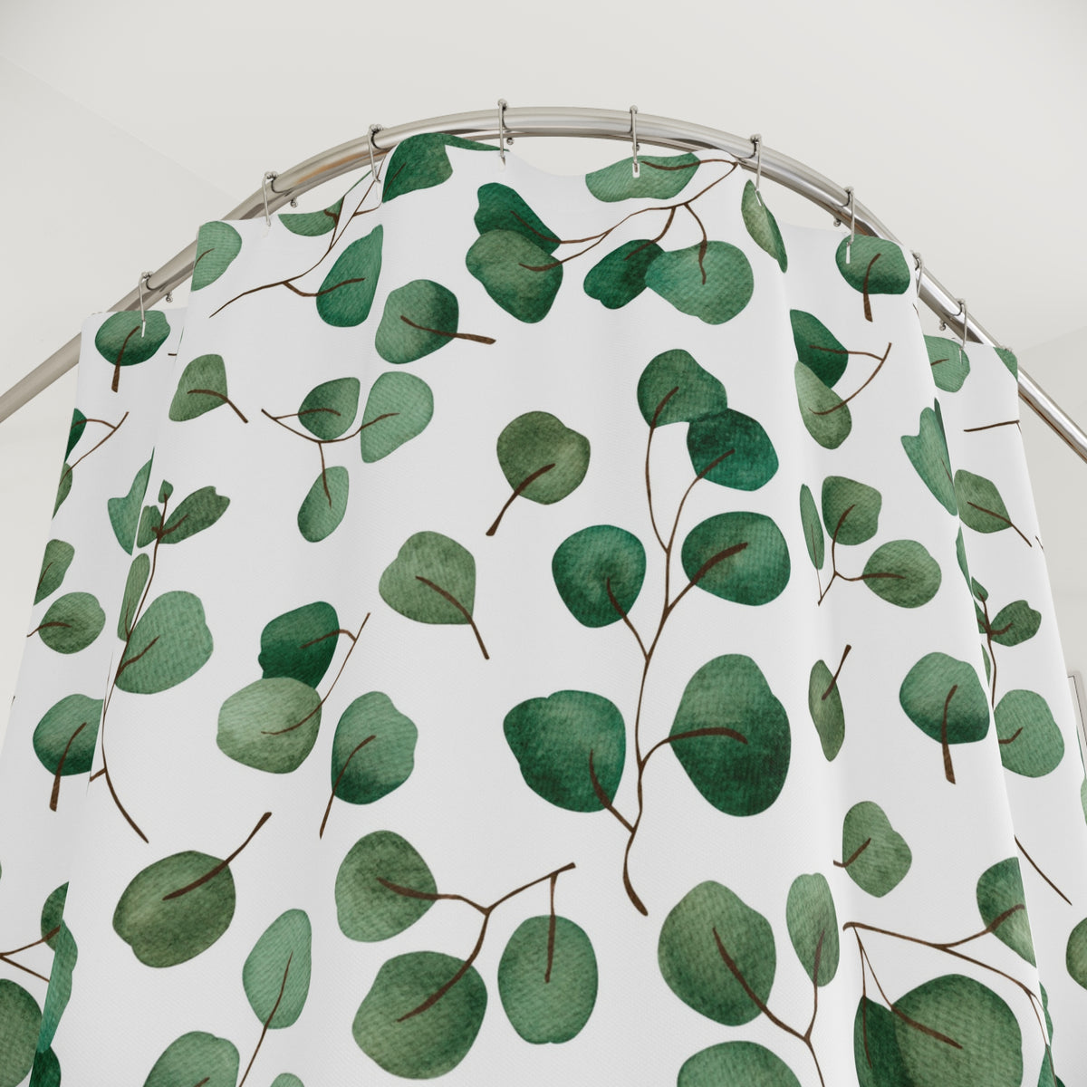 a shower curtain with a repeating pattern of green leaves and brown stems.