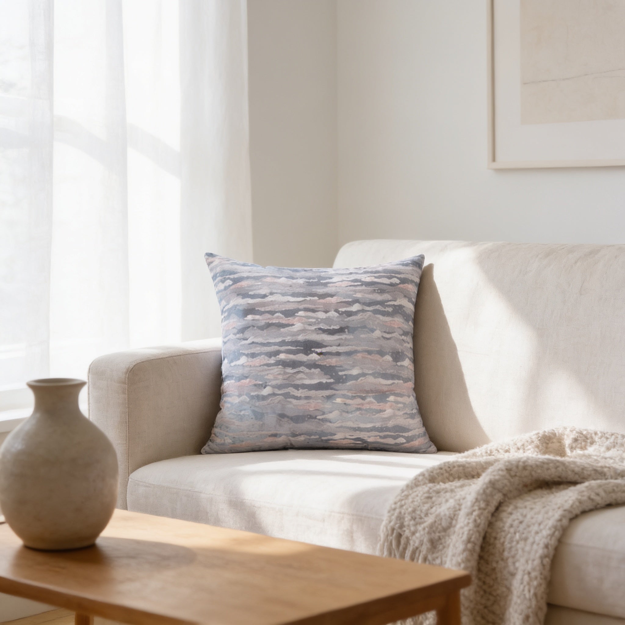 a cozy living room with a white sofa, a wooden coffee table, and a decorative pillow with a cloud pattern.