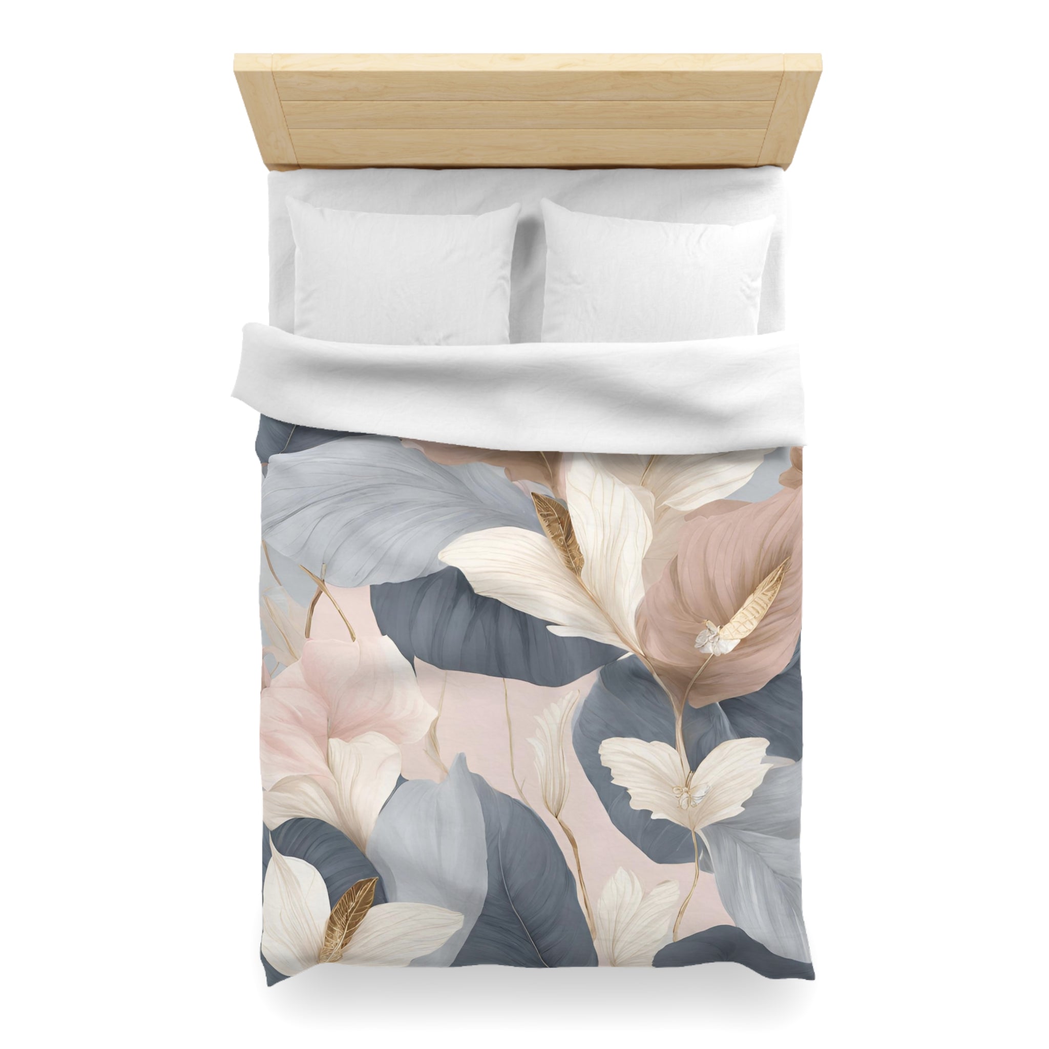 a bed with a floral patterned comforter and pillows.