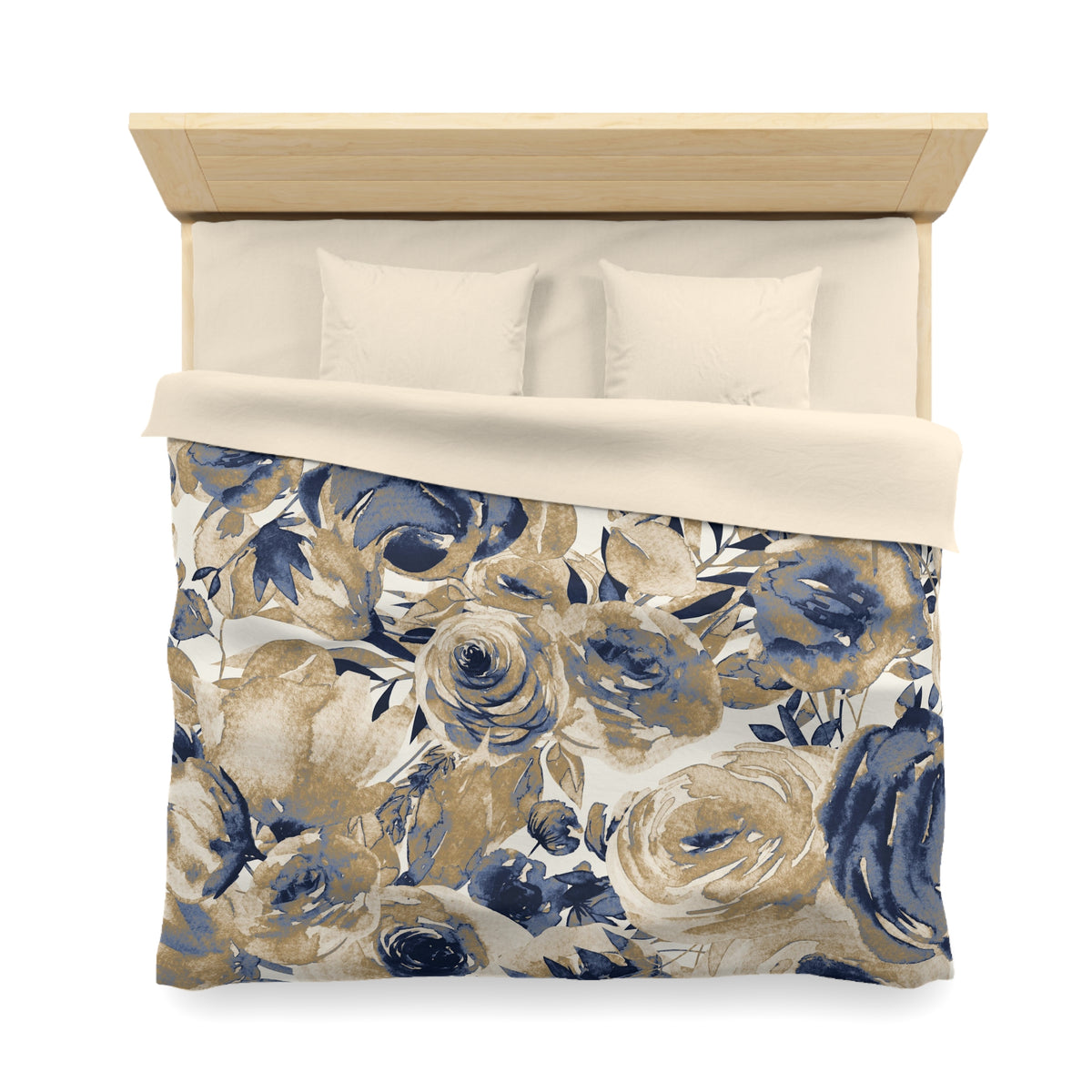 a bed with a floral print duvet cover and pillows. The duvet cover has a blue and gold floral pattern, and the pillows are white.