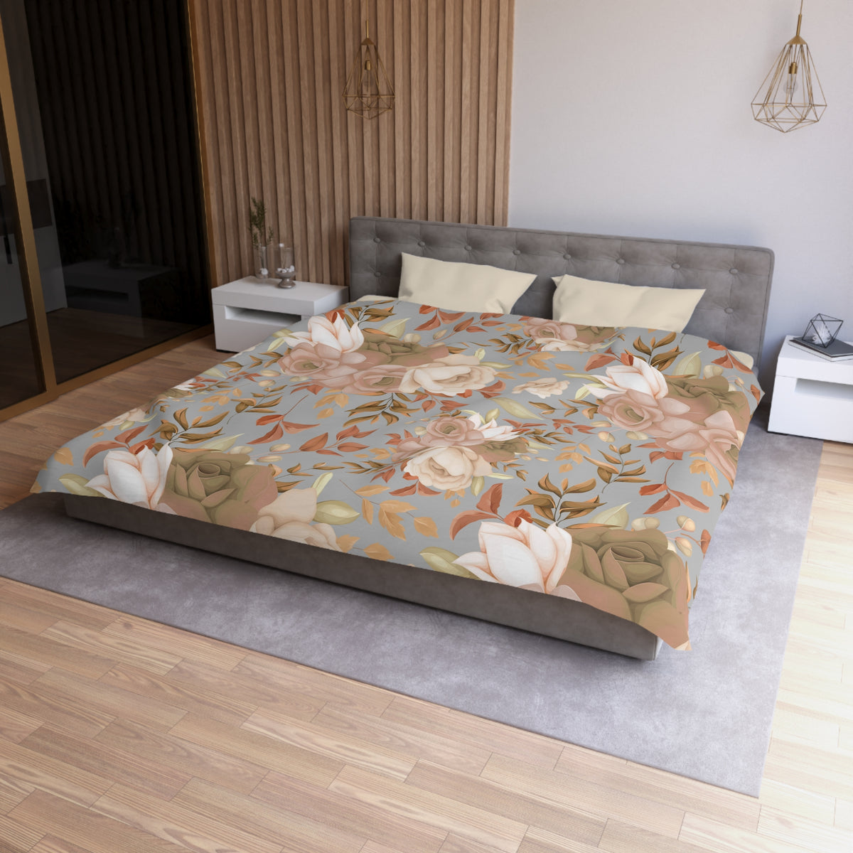 a modern bedroom with a large bed covered in a floral print comforter. The bed is positioned against a wall with a wooden paneling. The room also features a nightstand, a pendant light, and a vase on a surface.
