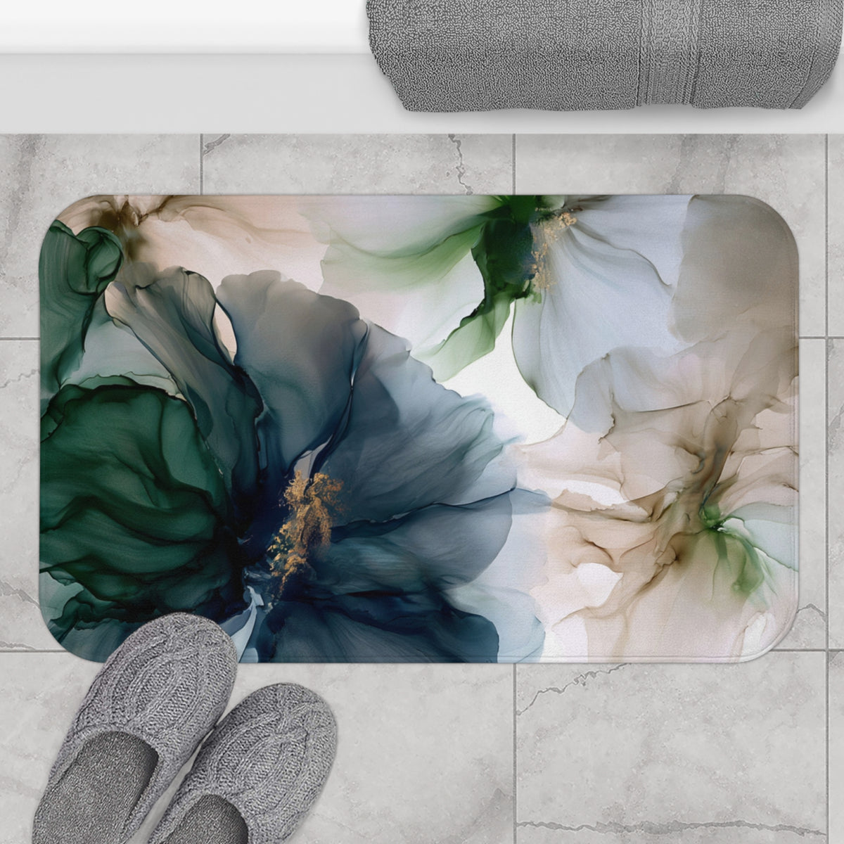 a pair of gray slippers sitting on top of a bathroom rug
