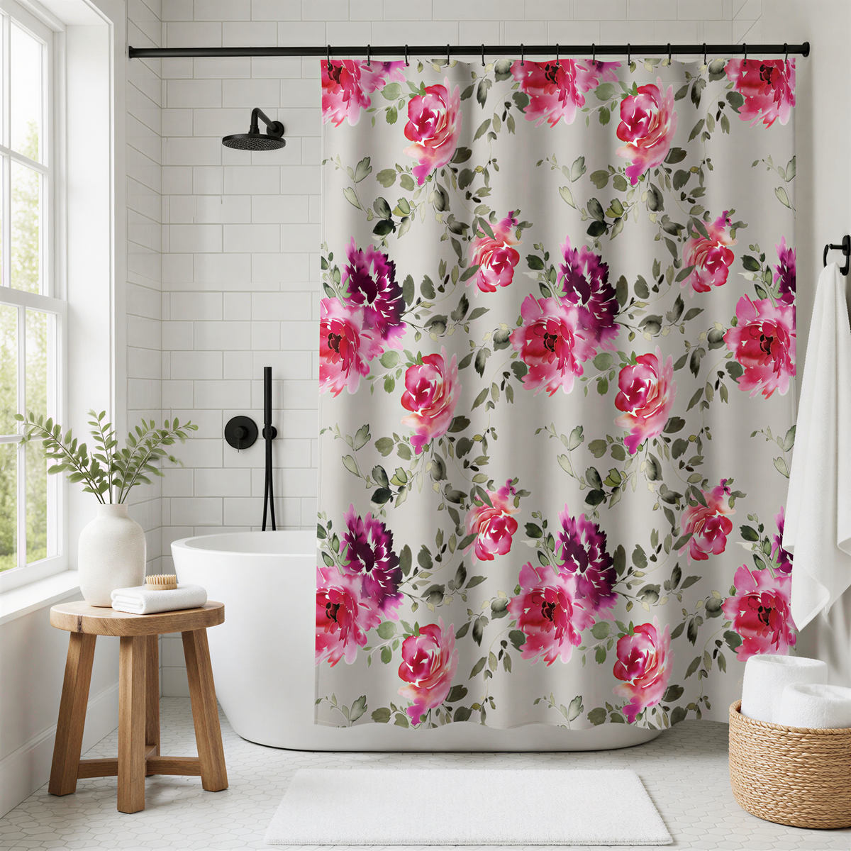 a bathroom with a floral shower curtain featuring pink and purple flowers. The shower curtain is hanging in front of a white bathtub, which is situated next to a window. The bathroom also includes a wooden stool, a basket, and a potted plant, creating a cozy and inviting atmosphere.