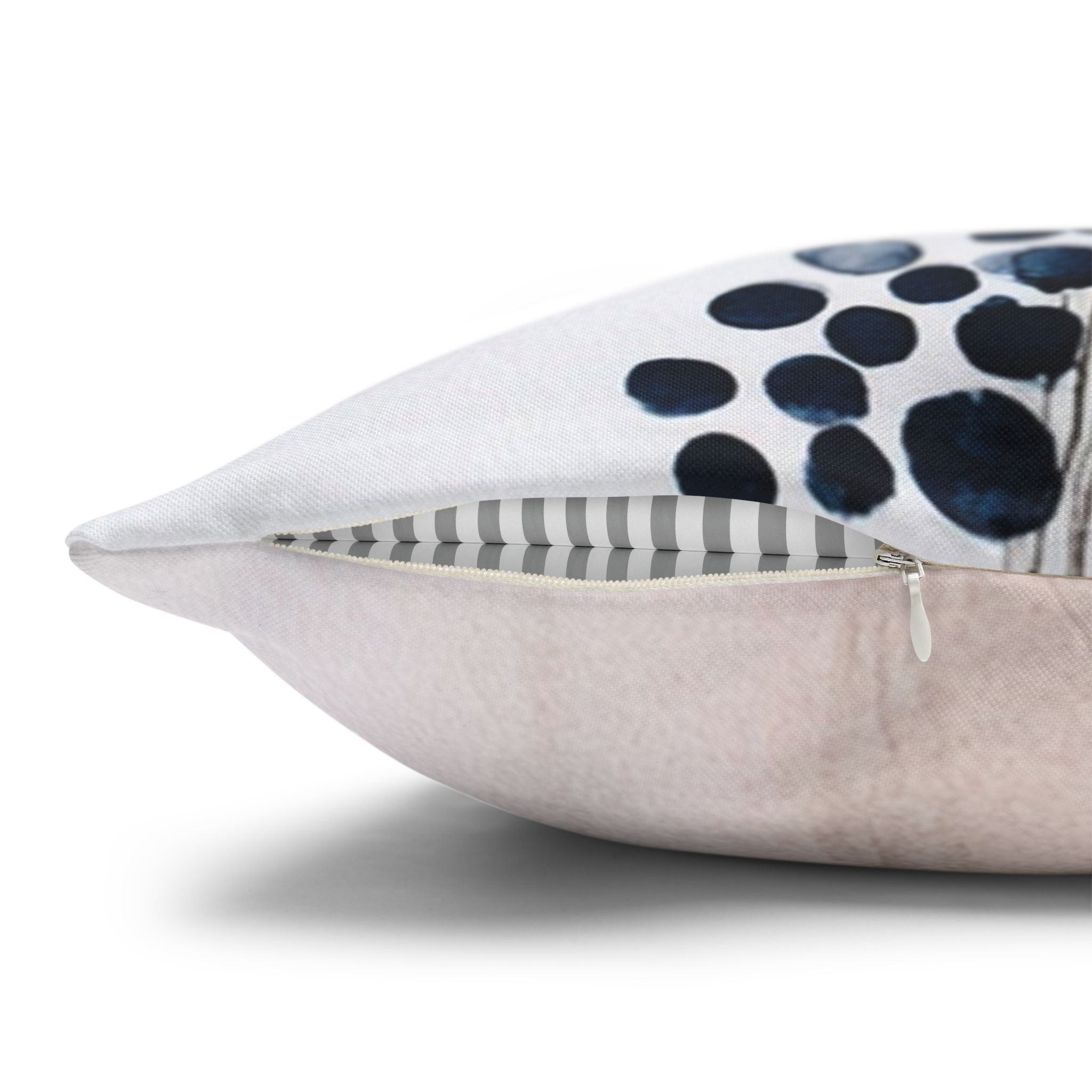 a close-up view of a white pillow with a black and white polka dot pattern on it.