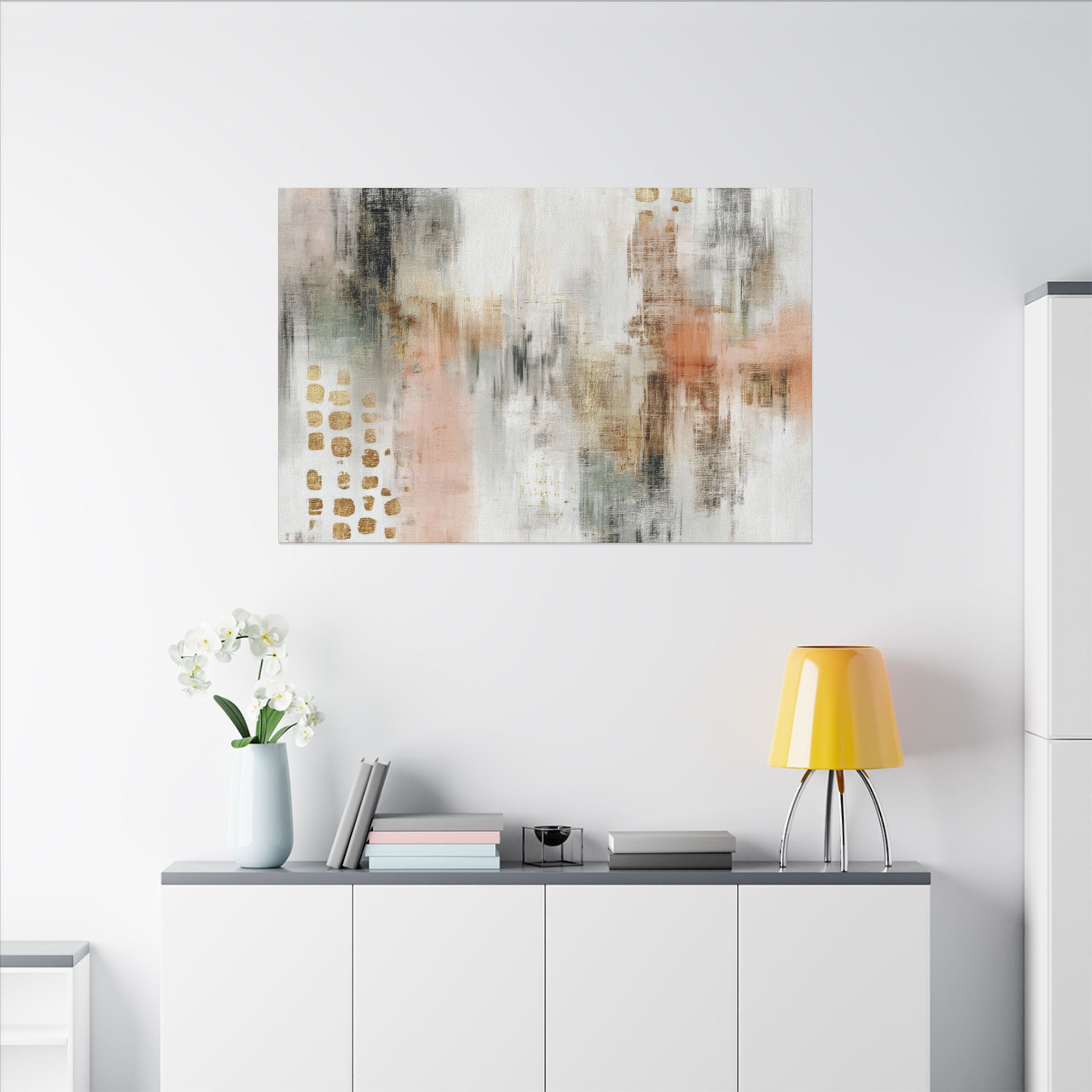 a modern living room with a white wall, a white cabinet, a yellow lamp, a vase with white flowers, and a painting hanging above the cabinet.