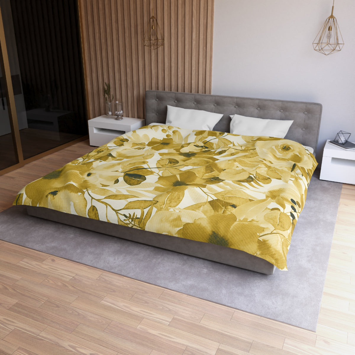 a modern bedroom with a large bed covered in a yellow and green floral comforter. The bed is positioned against a wall with a wooden panel. The room also features a nightstand, a pendant light, and a vase on a surface.