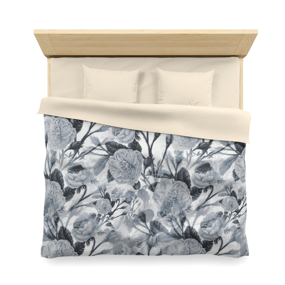 a neatly made bed with a floral patterned comforter and pillows.