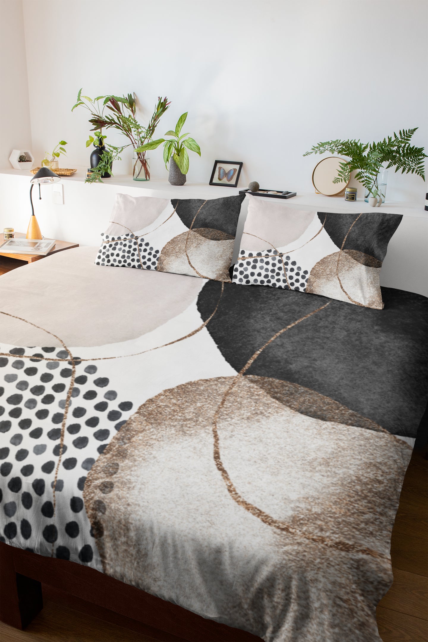 a bed with black and white sheets and pillows