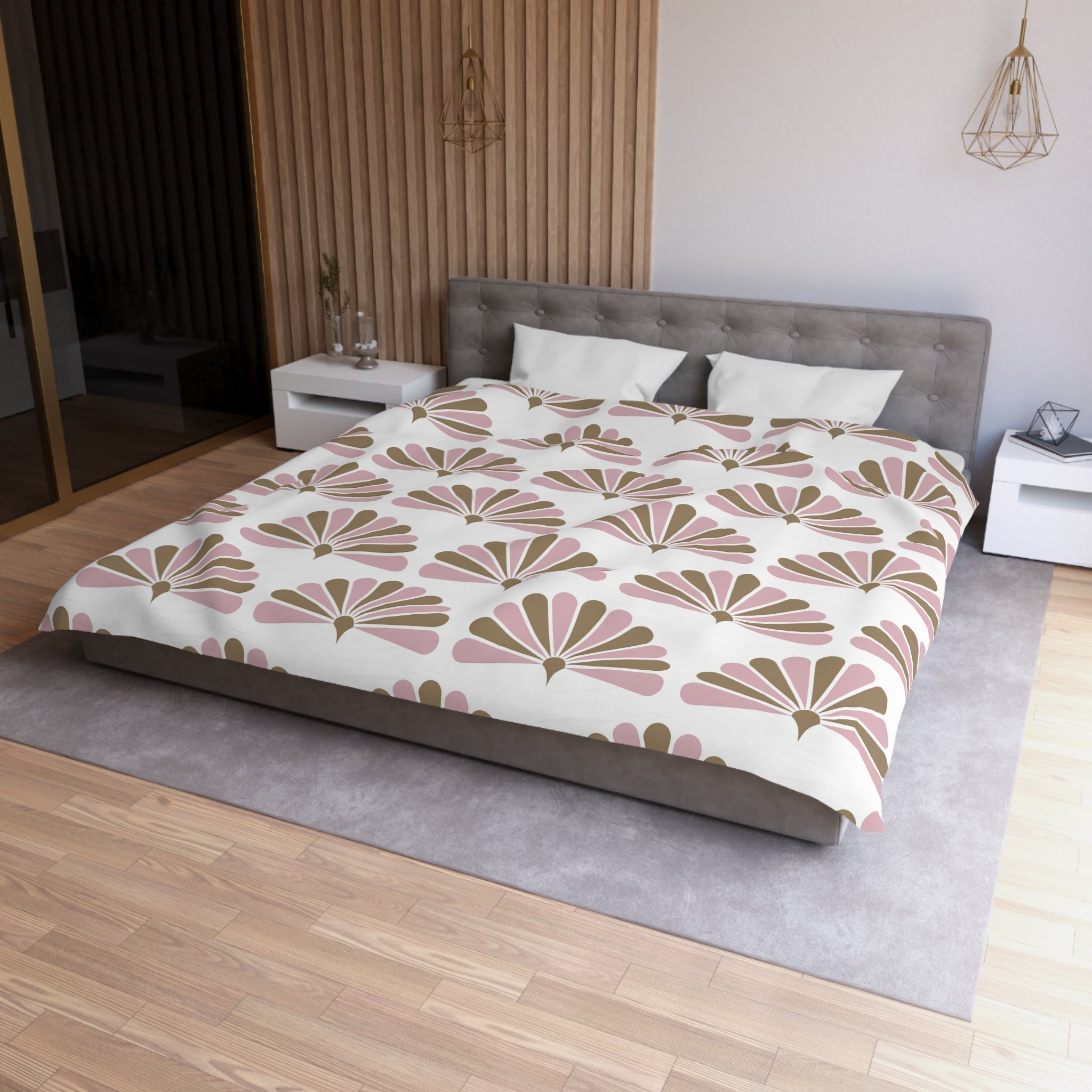a modern bedroom with a large bed, a gray headboard, and a white bedspread with a floral pattern. The room has a wooden floor and a white nightstand on each side of the bed. There is also a pendant light hanging above the bed.