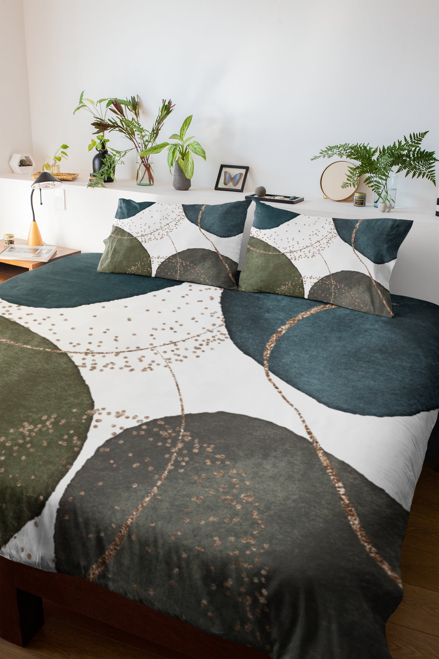 a bed with a green and white comforter and pillows