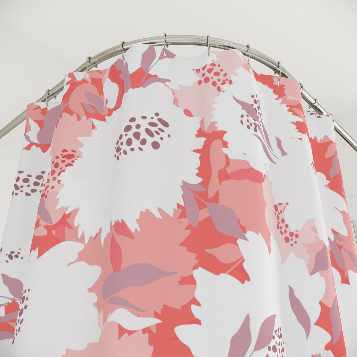 a shower curtain with a floral pattern in shades of pink and white.
