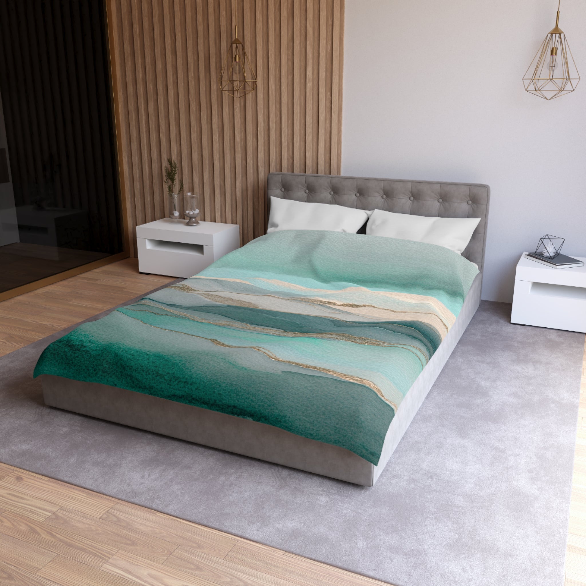 a modern bedroom with a large bed, a gray headboard, and a green and white patterned bedspread. The room has a neutral color scheme with white walls and a gray carpet. There are two nightstands on either side of the bed, and a pendant light hangs above the bed.