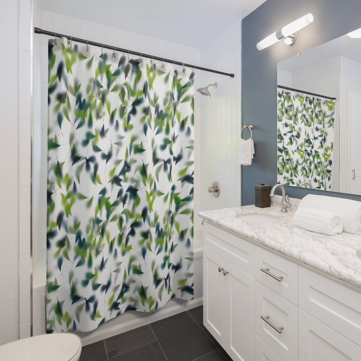 a modern bathroom with a white vanity, a green and white leaf-patterned shower curtain, and a mirror above the vanity.