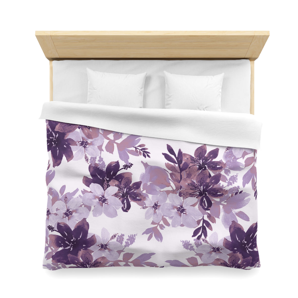 a neatly made bed with a floral print duvet cover featuring purple and white flowers. The bed has a wooden headboard and two white pillows.
