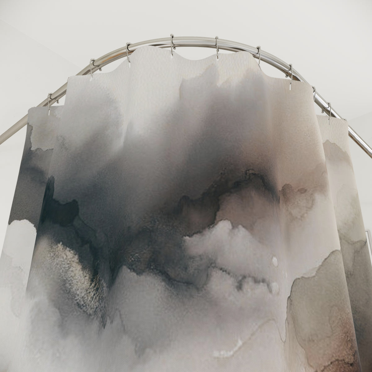 a shower curtain with a watercolor-style design depicting clouds or mist.