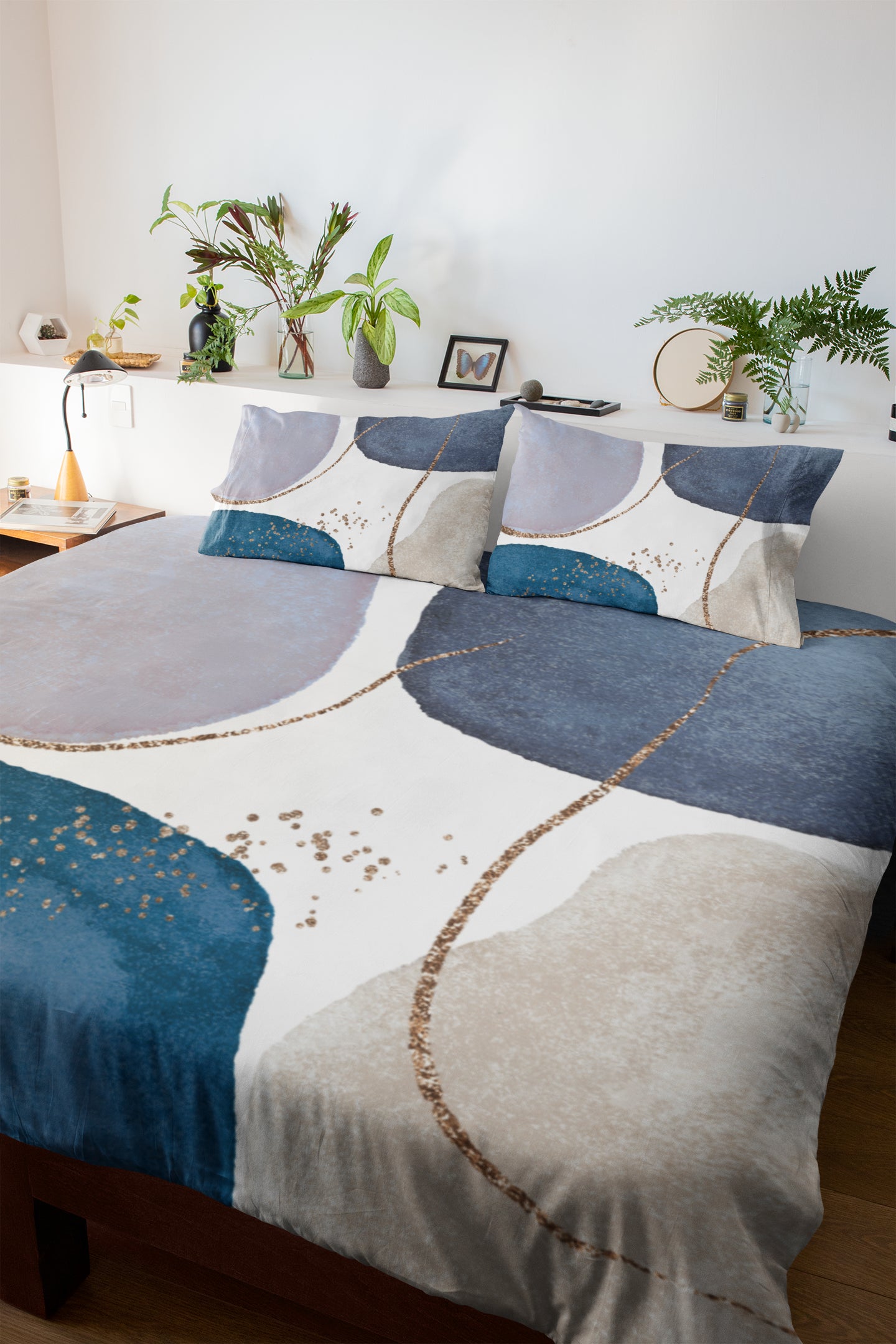 a bed with a blue and white comforter and pillows