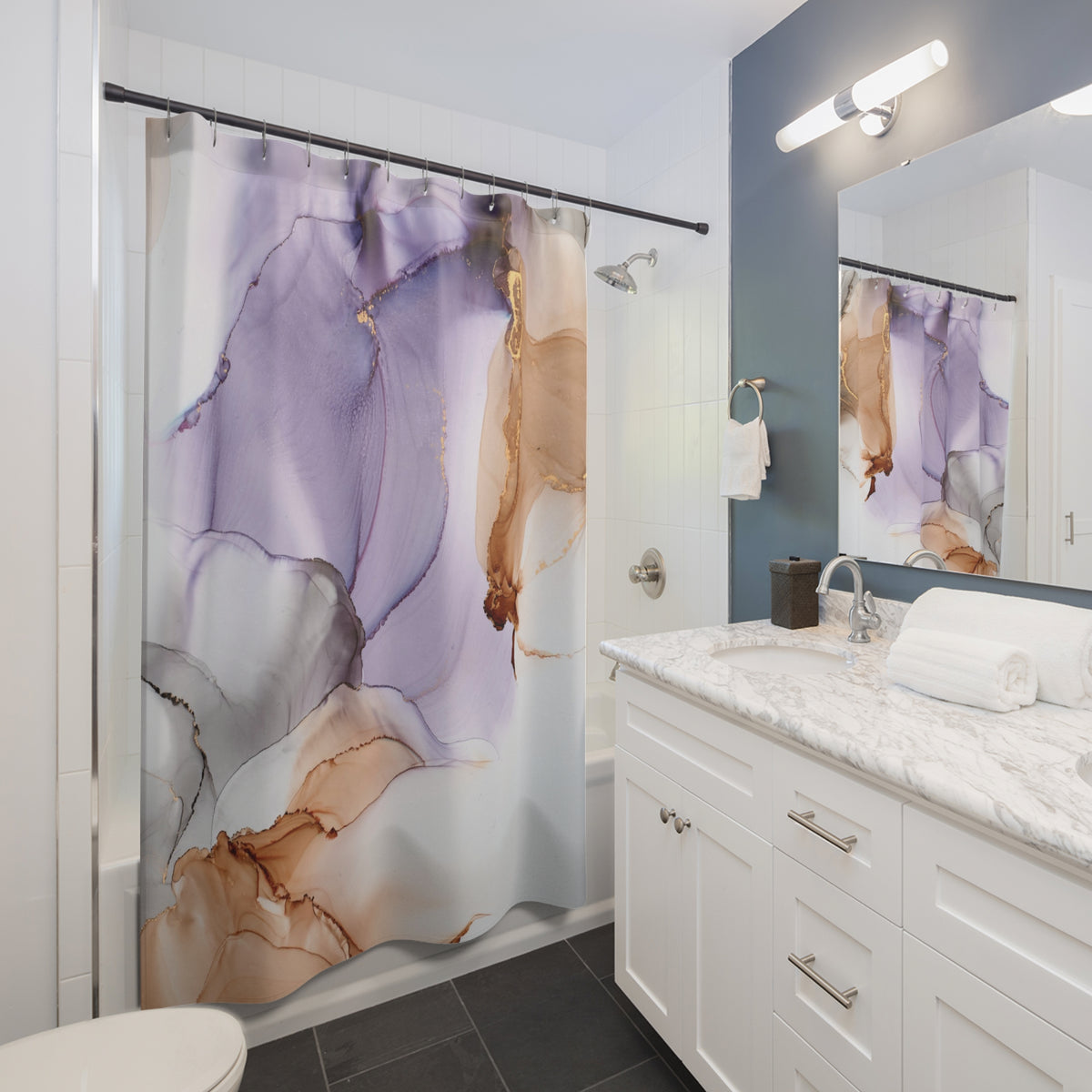 a modern bathroom with a white vanity, a shower curtain with a colorful abstract design, and a mirror above the vanity.
